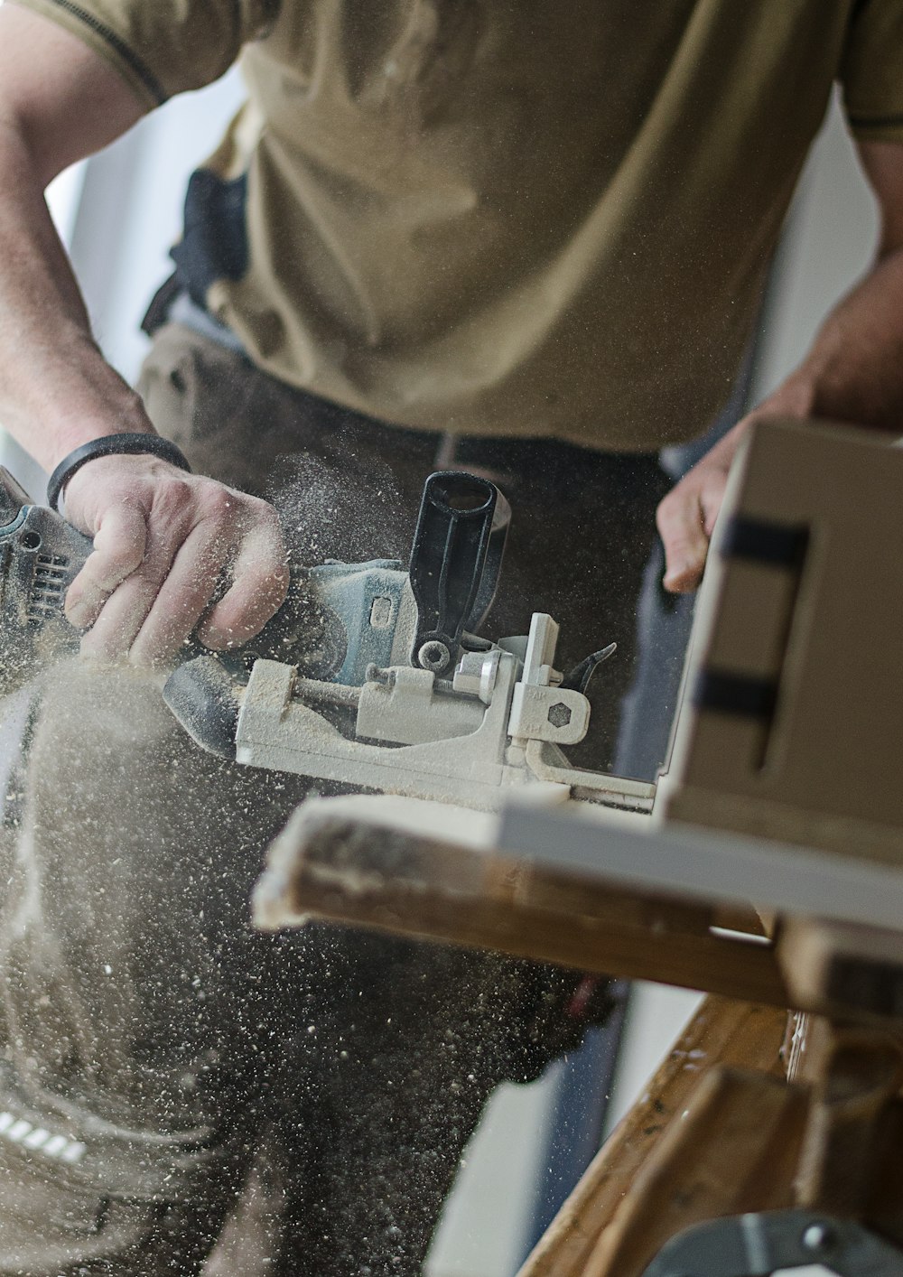 a worker sawing a board